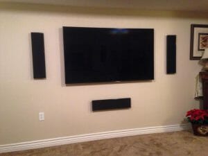 tv and speakers installed in wall by reeds built in