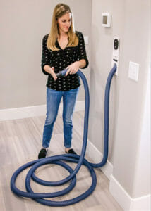 woman connecting central vacuum hose