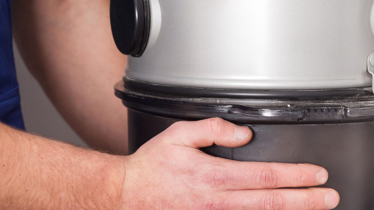 A specialist installing a central vacuum unit in a Utah home - What is a central vacuum? | Reed's Built-Ins